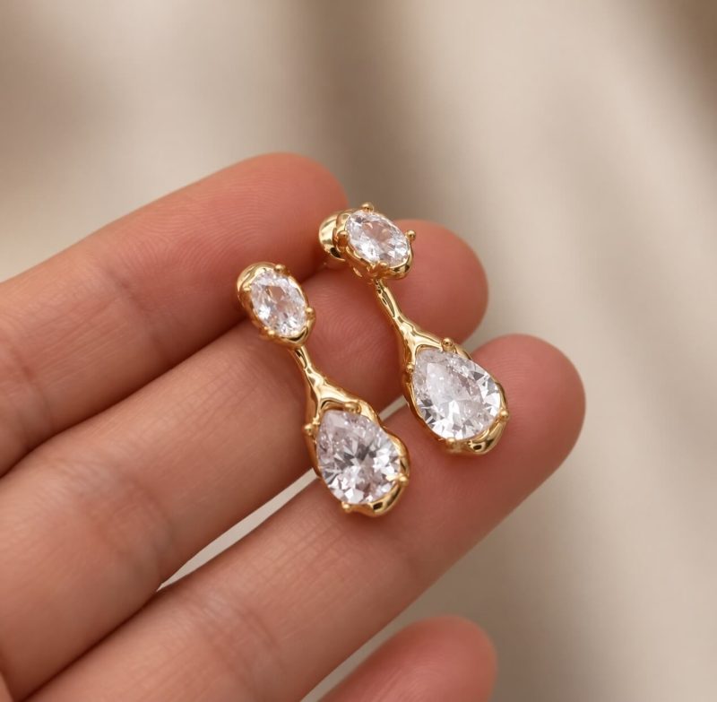 The Sidonie Earrings 1 Sidonie stud and drop earrings showing the oval zircon stud joined to the teardrop pendant
