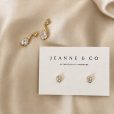 Close-up of the Sidonie Earrings, oval and teardrop zircon stones in softly sculpted settings
