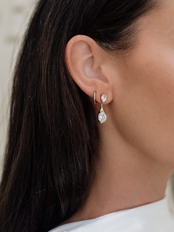 The Sidonie Earrings by Bone & Ivory, oval zircon studs with removable teardrop zircon drops in sculpted gold-plated settings