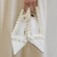odette-ruffle-satin-slingback-in-hand